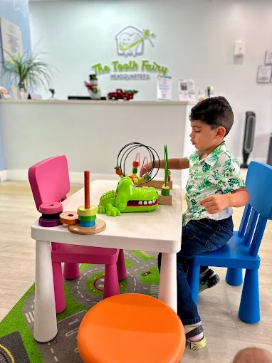 Child playing with toys in The Tooth Fairy HQ waiting area in North Lauderdale, FL