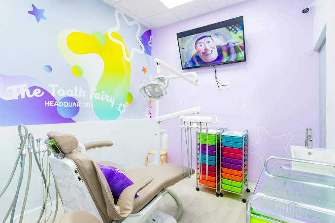 Private pediatric dental suite with purple walls and cartoon TV at The Tooth Fairy HQ