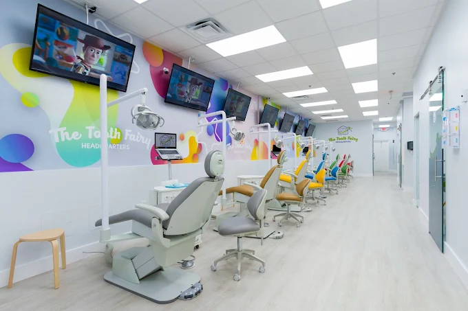 Colorful open treatment room with dental chairs and TVs at The Tooth Fairy HQ